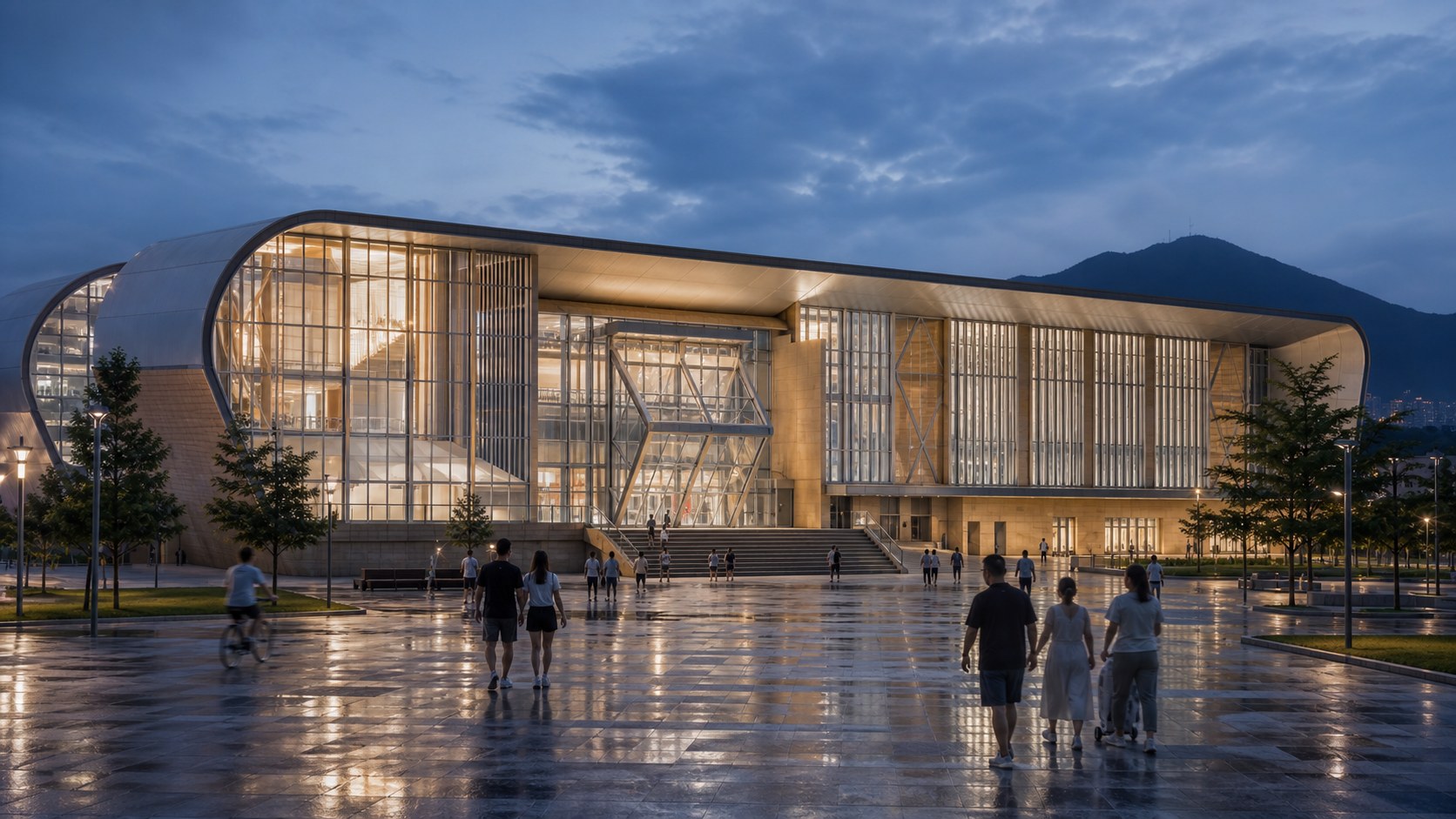 Visitors crossing the rain-washed plaza toward the illuminated Bay Arc Stadium at blue hour